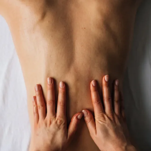 Close-up of the therapist's palms on a client's back