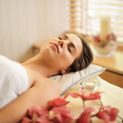 Massage table with orchids and a bowl of oil