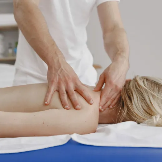 Gentle arm massage on a white towel